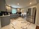 Modern kitchen featuring stainless steel appliances, stylish gray cabinetry, and elegant marble flooring at 910 Oriole Se Ln, Marietta, GA 30067