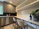Bright kitchen featuring stainless steel appliances, gray cabinetry and a bar counter at 910 Oriole Se Ln, Marietta, GA 30067