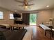 Cozy living room featuring a ceiling fan, wood floors, and sliding glass doors to the outside deck at 910 Oriole Se Ln, Marietta, GA 30067