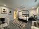 Spacious bedroom with a four-poster bed, office area, closet and neutral decor at 910 Oriole Se Ln, Marietta, GA 30067
