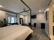 Airy main bedroom features desk space, bay window, and four-poster bed at 910 Oriole Se Ln, Marietta, GA 30067