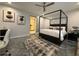 Stylish bedroom featuring a four-poster bed, closet, office space and contemporary design elements at 910 Oriole Se Ln, Marietta, GA 30067