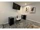Modern office space with glass desk. Also features sink, artwork, and large wall-mounted TV at 910 Oriole Se Ln, Marietta, GA 30067