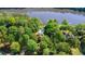Aerial view showcasing a beautiful home nestled amongst trees with a pool and serene lake access at 1240 Bridgewater Walk, Snellville, GA 30078