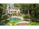 Aerial view of the backyard features a pool, patio, and landscaped garden at 1240 Bridgewater Walk, Snellville, GA 30078