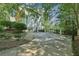 Back exterior of home showcasing an oversized driveway with a basketball hoop at 1240 Bridgewater Walk, Snellville, GA 30078