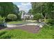 Beautifully landscaped backyard with inground pool and elegant home exterior provide an idyllic setting for outdoor enjoyment at 1240 Bridgewater Walk, Snellville, GA 30078
