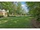 Expansive backyard with lush green lawn, beautiful landscaping, a refreshing pool, and serene lake views at 1240 Bridgewater Walk, Snellville, GA 30078