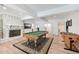 Finished basement features a stone fireplace, a pool table, and wood flooring at 1240 Bridgewater Walk, Snellville, GA 30078