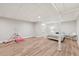 Large basement featuring wood-look flooring, gym equipment, and a cozy sleeping area at 1240 Bridgewater Walk, Snellville, GA 30078