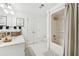 Bright bathroom featuring a shower, ample linen storage, and vanity with dual sinks at 1240 Bridgewater Walk, Snellville, GA 30078