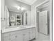 Well-lit bathroom featuring a bright vanity, storage, and a doorway leading to another room at 1240 Bridgewater Walk, Snellville, GA 30078