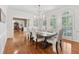 Dining room features hardwood floors, a chandelier, and large windows with shutters at 1240 Bridgewater Walk, Snellville, GA 30078