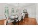 Elegant dining room with hardwood floors, chandelier, and large windows at 1240 Bridgewater Walk, Snellville, GA 30078