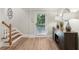 Inviting entryway with wood staircase, storage cabinet, and door to the outside at 1240 Bridgewater Walk, Snellville, GA 30078