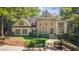 Beautiful stone and stucco home with manicured landscaping and a charming fountain in a circular driveway at 1240 Bridgewater Walk, Snellville, GA 30078