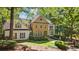 Stately stone and stucco home nestled in lush greenery with mature trees and fountain landscaping at 1240 Bridgewater Walk, Snellville, GA 30078