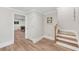 Hallway leading to the basement with stairs and stylish flooring, with games room visible at 1240 Bridgewater Walk, Snellville, GA 30078