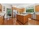 The kitchen has wood cabinets, granite countertops, and stainless steel appliances at 1240 Bridgewater Walk, Snellville, GA 30078