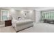 Bright main bedroom featuring a tufted bed frame, tray ceiling, and plantation shutters at 1240 Bridgewater Walk, Snellville, GA 30078