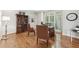Bright home office featuring hardwood floors, a large window, and an executive desk at 1240 Bridgewater Walk, Snellville, GA 30078