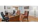 Functional home office with wood floors, a desk, and additional chairs for guests at 1240 Bridgewater Walk, Snellville, GA 30078