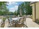 Inviting outdoor dining area with a table setting overlooking the pool and lake views at 1240 Bridgewater Walk, Snellville, GA 30078
