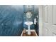 Elegant powder room showcasing unique wallpaper, a pedestal sink, and designer mirror at 1240 Bridgewater Walk, Snellville, GA 30078