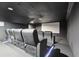 Home theater room with reclining seats, projector, and a large screen at 1240 Bridgewater Walk, Snellville, GA 30078