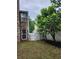 Cozy backyard featuring a white fence, well maintained lawn, and beautiful tree at 2320 Glynmoore Dr, Lawrenceville, GA 30043