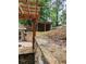 Backyard area with a wooden pergola, stone walls, and outdoor space for storage at 2320 Glynmoore Dr, Lawrenceville, GA 30043