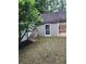 Backyard of home with a garden storage shed featuring a brick patio and stone stairs at 2320 Glynmoore Dr, Lawrenceville, GA 30043