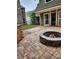 Backyard outdoor patio with stone fire pit, brick pavers, and outdoor storage at 2320 Glynmoore Dr, Lawrenceville, GA 30043