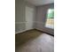 Bedroom featuring wall trim, an electrical outlet and a large window at 2320 Glynmoore Dr, Lawrenceville, GA 30043