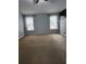 Large bedroom features carpet, dual windows with natural light, and a modern ceiling fan at 2320 Glynmoore Dr, Lawrenceville, GA 30043