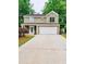 Charming two-story home featuring a spacious two-car garage and a well-manicured lawn at 2320 Glynmoore Dr, Lawrenceville, GA 30043
