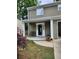 Covered front porch showcasing a decorative door, seating area and landscaping at 2320 Glynmoore Dr, Lawrenceville, GA 30043