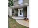 Inviting front porch features an ornate glass front door, outdoor seating and manicured landscaping at 2320 Glynmoore Dr, Lawrenceville, GA 30043