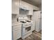 Kitchen with modern appliances, white cabinets, and stylish backsplash at 2320 Glynmoore Dr, Lawrenceville, GA 30043