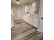 Kitchen featuring white cabinetry, modern faucet, and hardwood floors at 2320 Glynmoore Dr, Lawrenceville, GA 30043