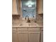 Bright kitchen sink and countertop area with view to adjacent living space at 2320 Glynmoore Dr, Lawrenceville, GA 30043
