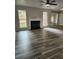 Open-concept living room with hardwood floors, a fireplace, and large windows at 2320 Glynmoore Dr, Lawrenceville, GA 30043