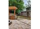 Outdoor kitchen with stone fire pit and wood pergola with access to the backyard and additional building at 2320 Glynmoore Dr, Lawrenceville, GA 30043