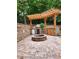 Outdoor kitchen with stone fire pit and wood pergola, great for backyard entertaining at 2320 Glynmoore Dr, Lawrenceville, GA 30043
