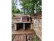 Outdoor space features a functional pizza oven with stone surrounding and stone walls at 2320 Glynmoore Dr, Lawrenceville, GA 30043