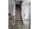 Staircase showcasing hardwood floors, white railings and neutral colored walls at 2320 Glynmoore Dr, Lawrenceville, GA 30043