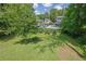 Expansive backyard with lush lawn, mature trees, and an in-ground pool at 2673 Deerfield Sw Cir, Marietta, GA 30064
