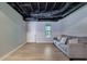 Finished basement featuring a cozy seating area and exposed ceiling at 2673 Deerfield Sw Cir, Marietta, GA 30064