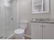 Bathroom featuring a glass door shower, granite countertop and white toilet at 2673 Deerfield Sw Cir, Marietta, GA 30064
