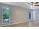 Bright bedroom features wood flooring, ceiling fan, and natural light from large windows at 2673 Deerfield Sw Cir, Marietta, GA 30064